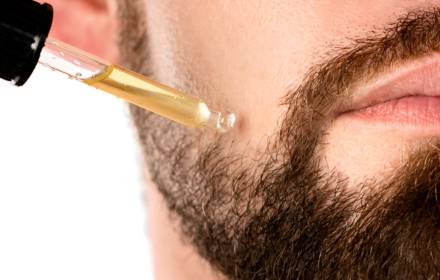 Applying beard oil with dropper for nourishment